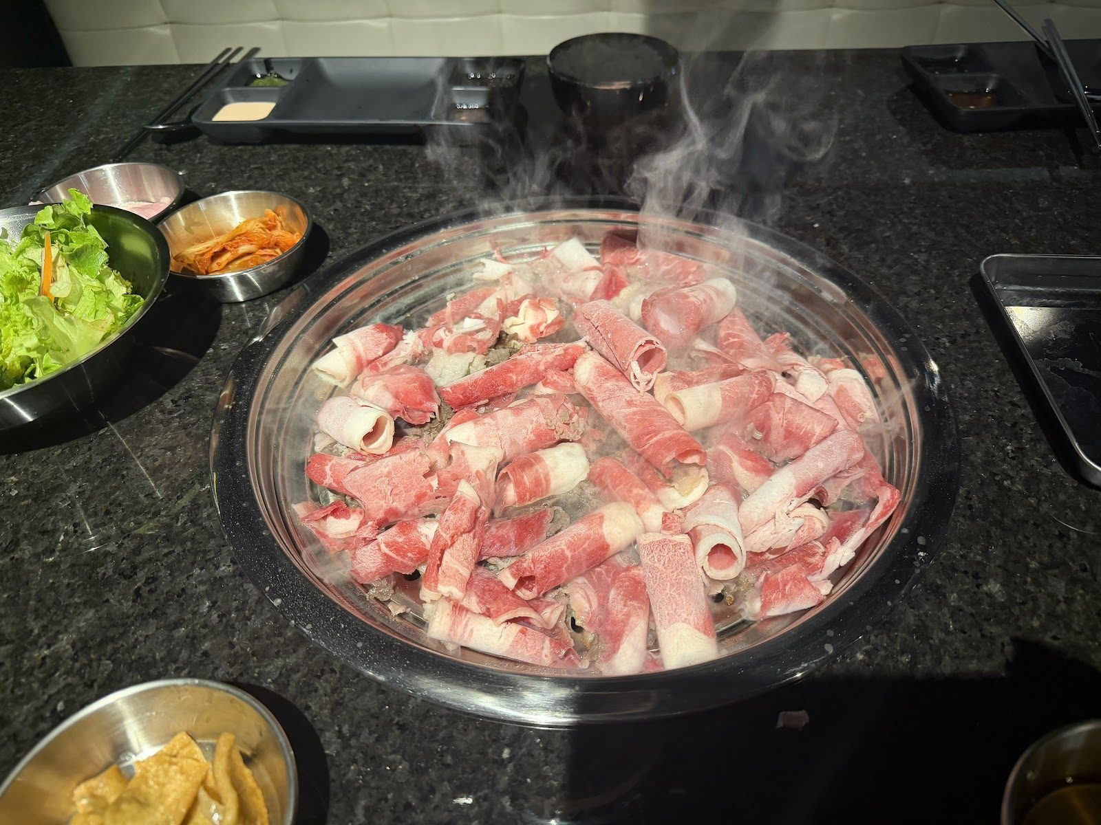 Sliced meat on the grill at Khan Korean Grill & Bar in Sterling